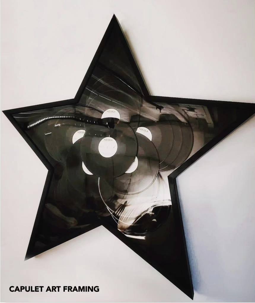 Star-shaped custom framing of vinyl records on a wall